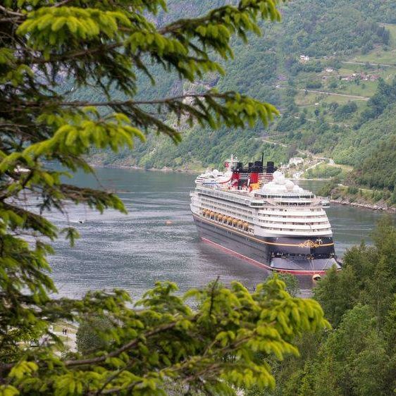 Ocean cruise ship sailing through a Norwegian fjord