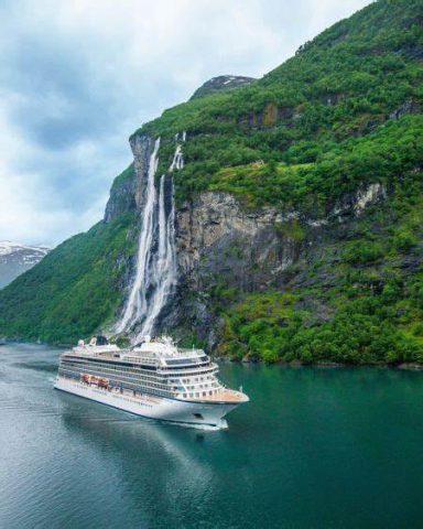 Cruise ship sailing through a Norwegian fjord